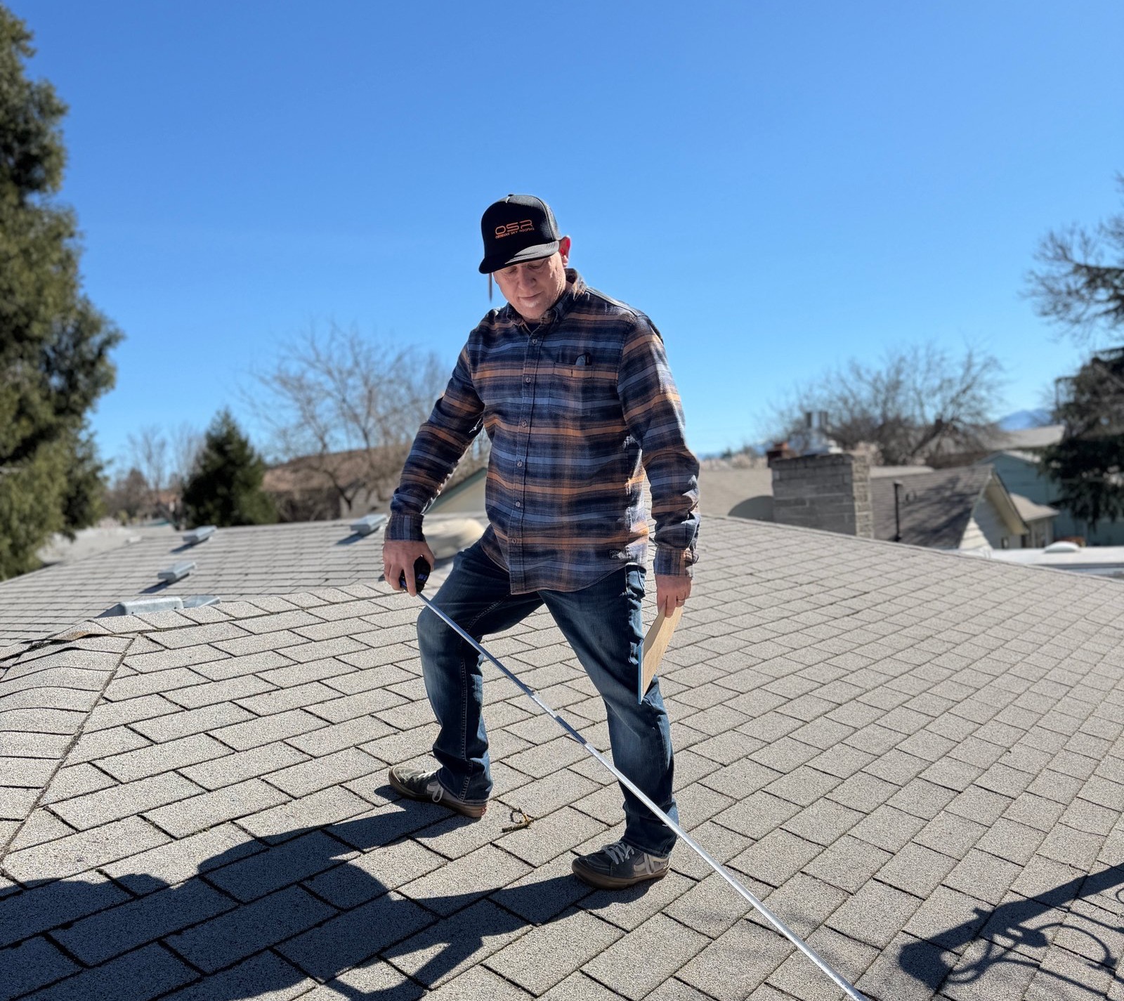 A local homeowner meeting with Obsidian Sky Roofing about a roof estimate