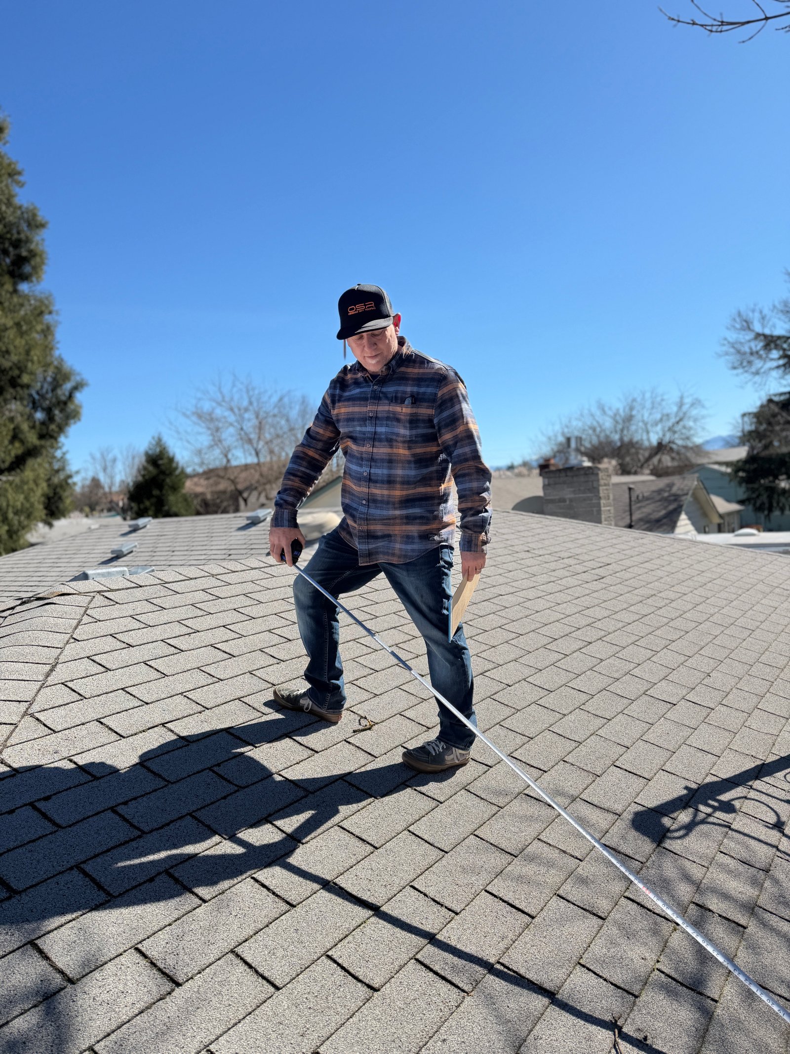 A local homeowner meeting with Obsidian Sky Roofing about a roof estimate