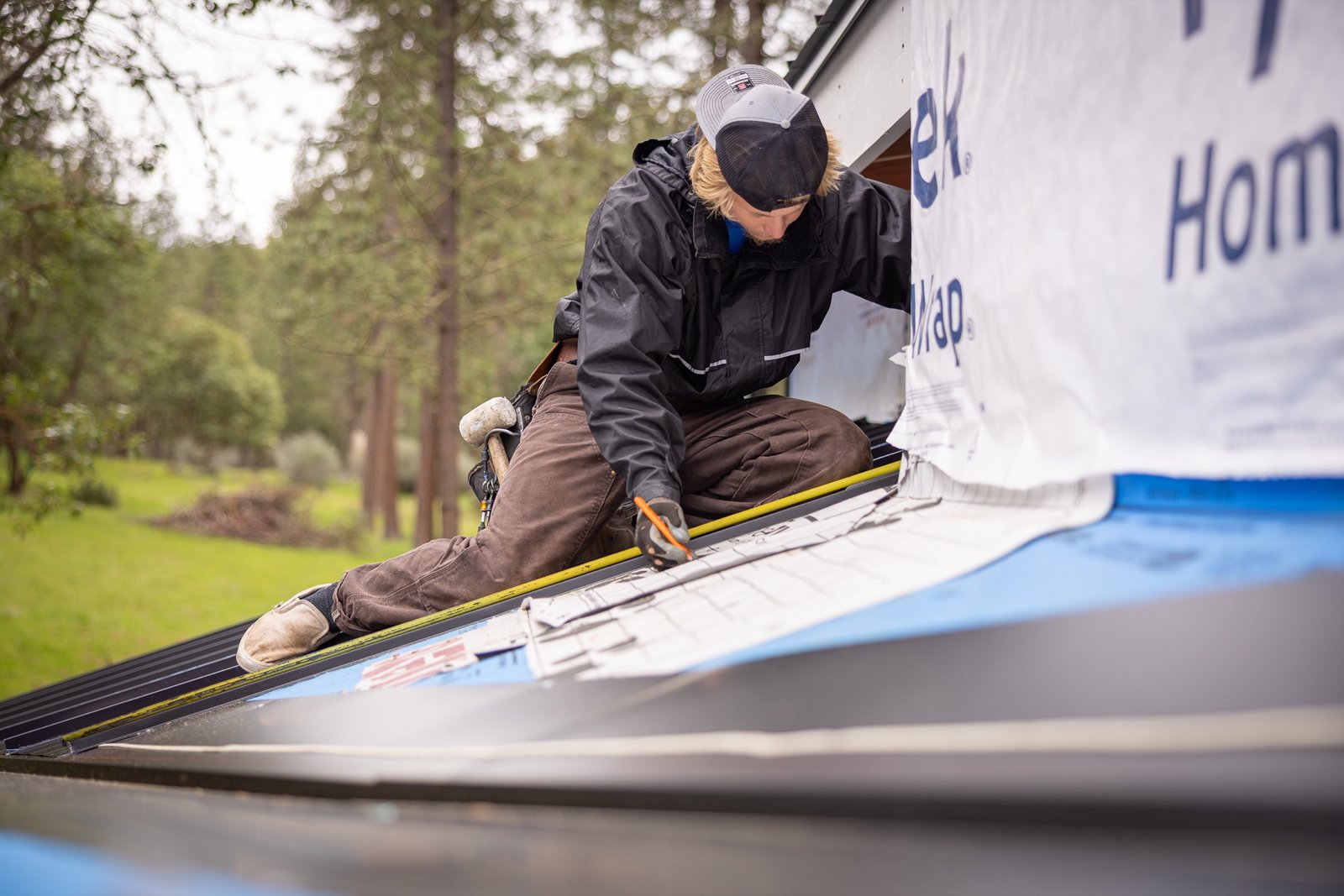 Obsidian Sky Roofing crew member working on a residential roof